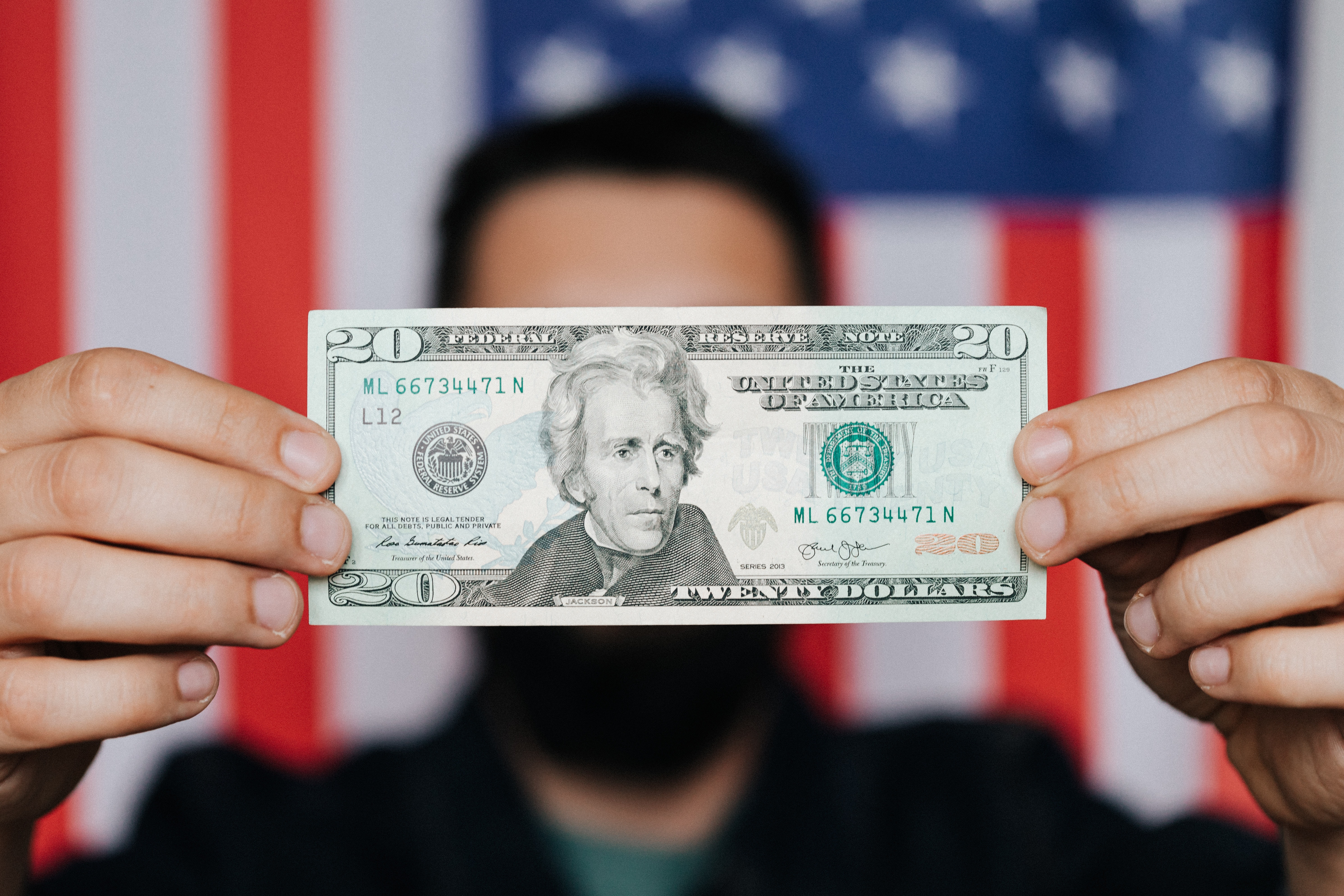 Man holding $20 bill.