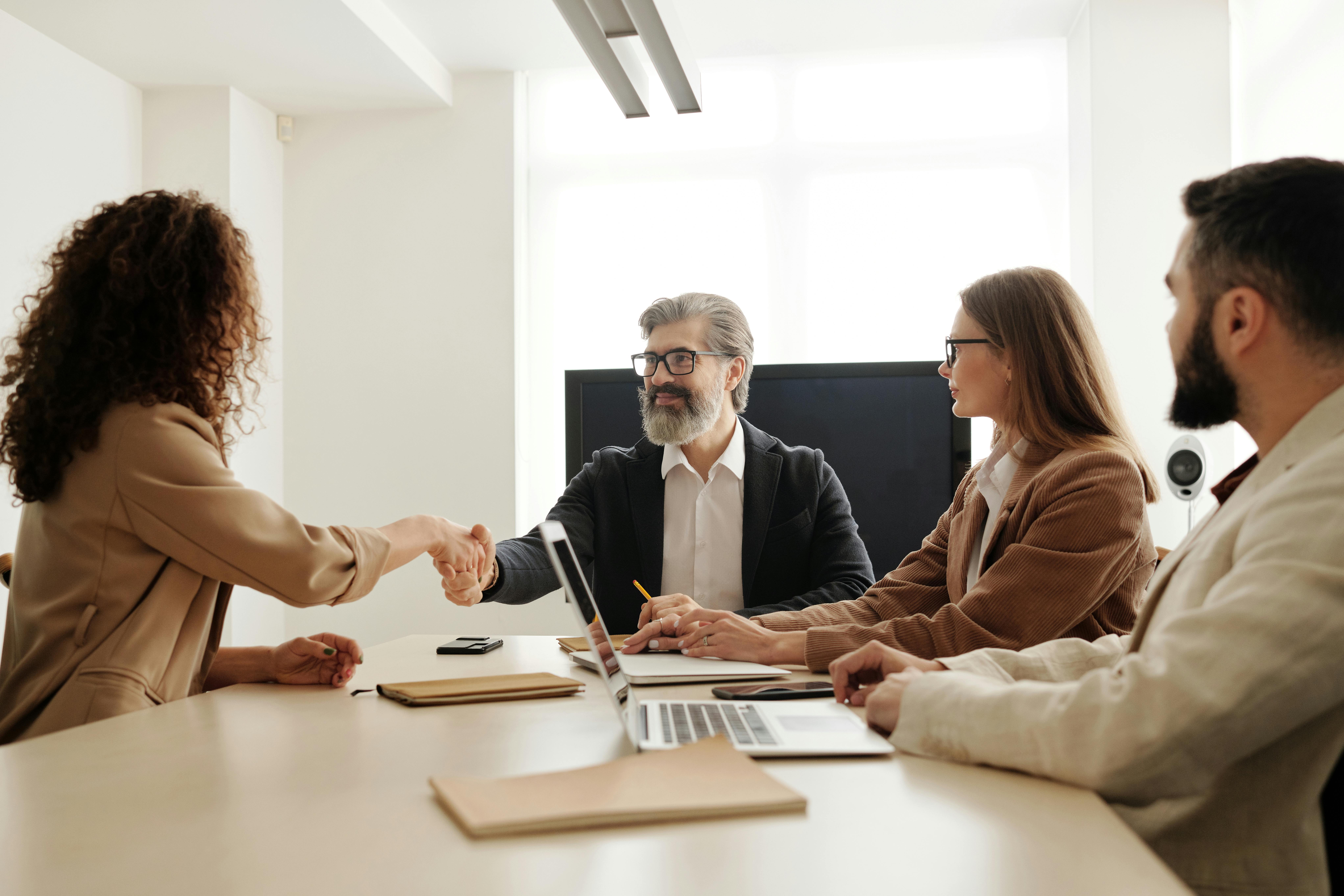 Person shaking hands during an interview.