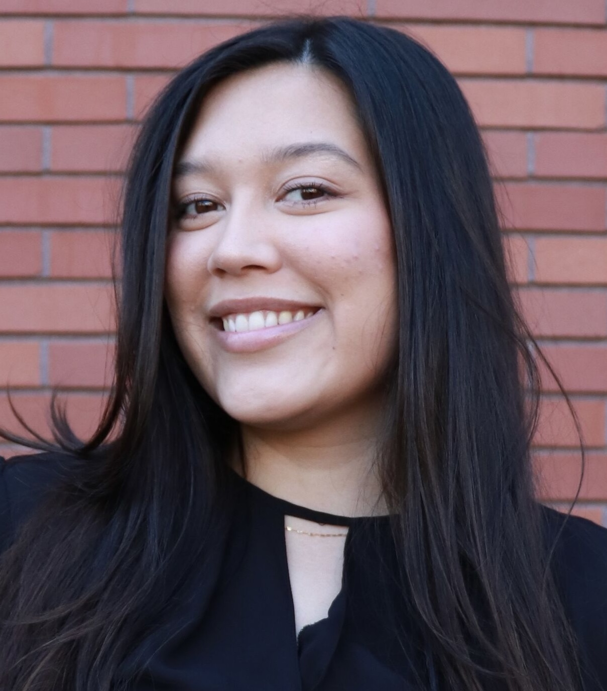 Smiling headshot of MGT 426 alum Jayda Ortiz in black blouse